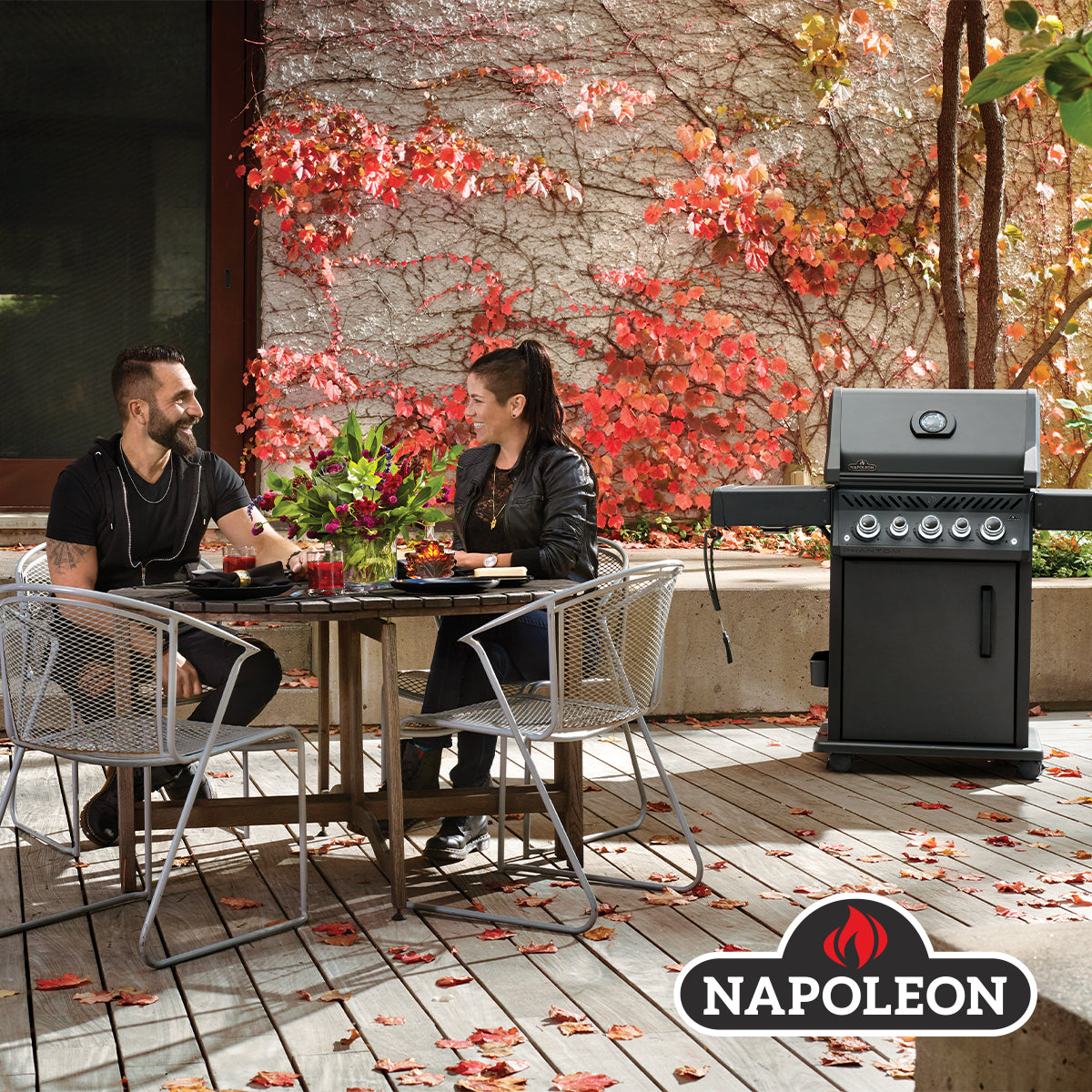 COUPLE SEATING NEXT TO A NAPOLEON GRILL