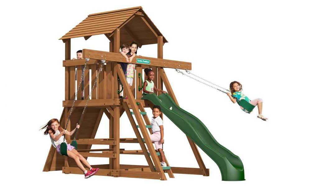 kids playing around the Space saver swing set with slide and rock wall 